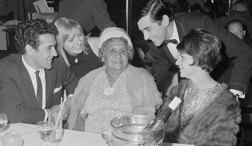 A black-and-white photograph of Charles Perkins and members of his family enjoying a night out at the Silver Spade Room at the Chevron Hilton Hotel, Sydney, May 1966. Photograph by Alec Iverson.  
